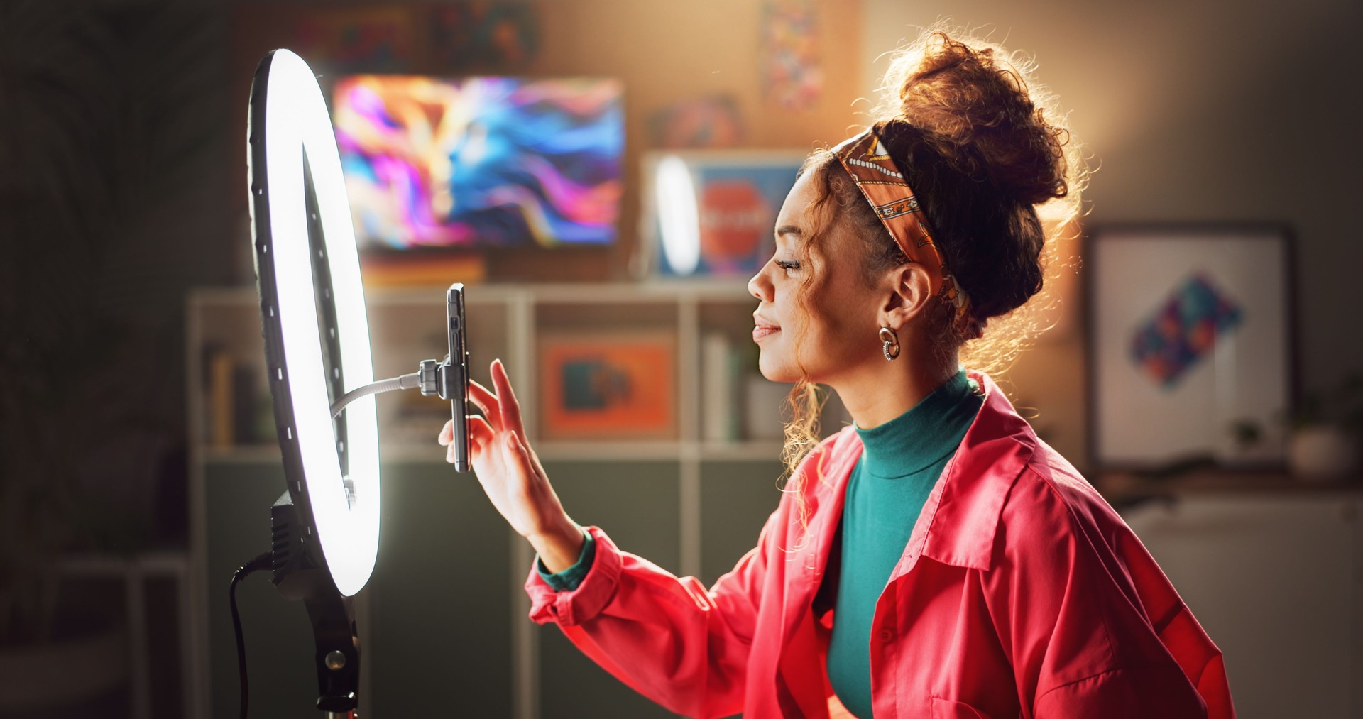 Woman, influencer and phone with ring light for video recording, vlogging or online tutorial at home. Young, female person or vlogger setting up mobile smartphone for advice, tips or content creation